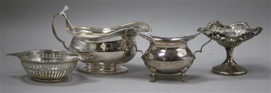 A silver sauce boat, a silver oval small sugar bowl, a pierced silver two-handled sweetmeat dish and a pierced pedestal dish